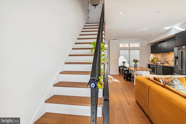 a view of a living room with furniture and a flat screen tv