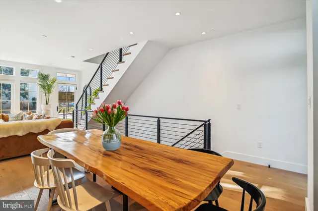 a dining room with furniture and a floor to ceiling window