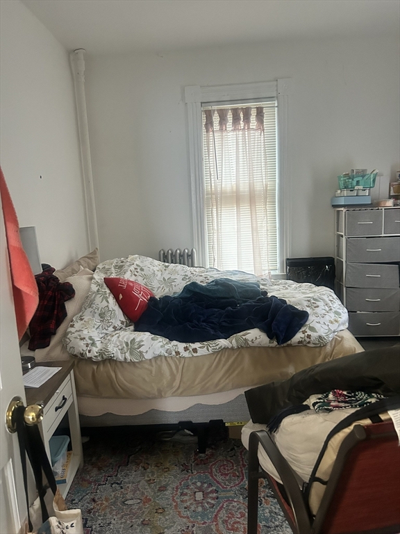 51 Acushnet Avenue Springfield, MA 01105 - Photo 19 of 22 a bedroom with a bed and wooden floor