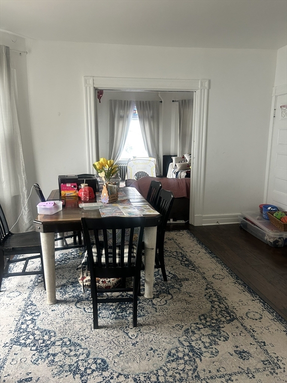 51 Acushnet Avenue Springfield, MA 01105 - Photo 4 of 22 a view of a dining room and livingroom with furniture wooden floor and a rug