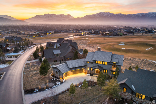 707 Chimney Rock Road, Unit 247 Heber City, UT 84032 - Photo 47 of 64 Aerial perspective of suburban area featuring a mountain backdrop and a local golf course
