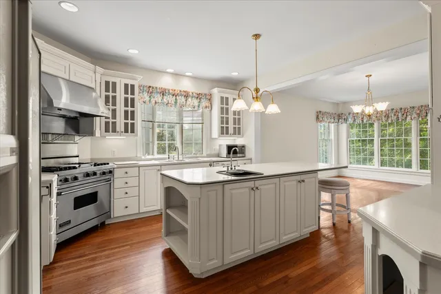 a large kitchen with stainless steel appliances a lot of counter space and wooden floors