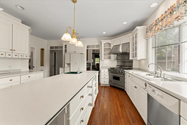 a kitchen with a sink stove and cabinets