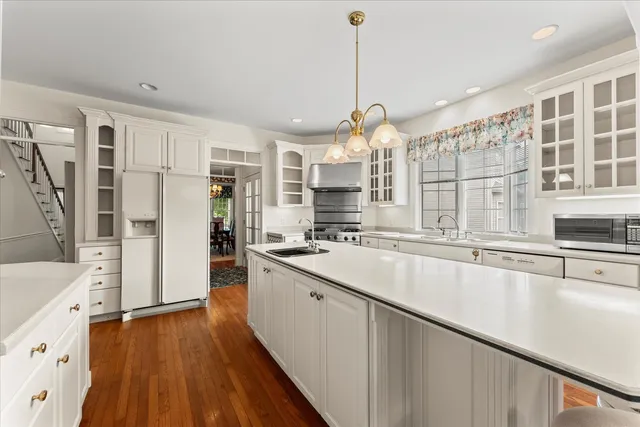 a view of a room with wooden floor furniture and windows
