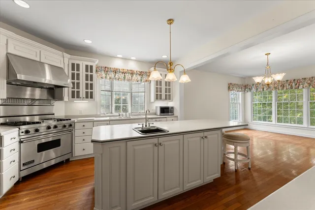 an empty room with windows and fireplace
