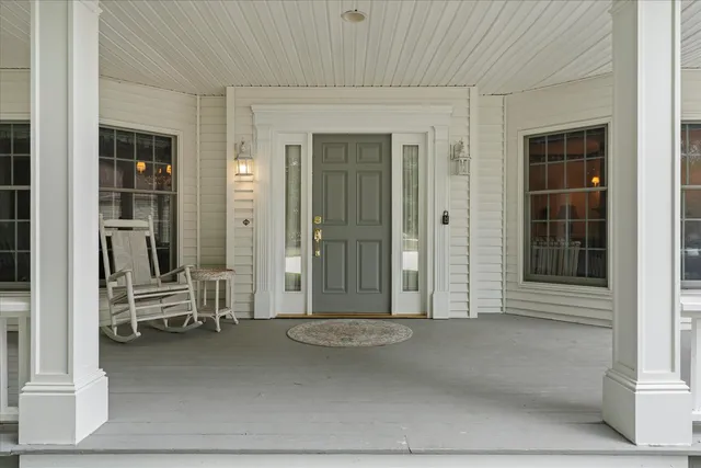 a view of a porch with chairs and couches