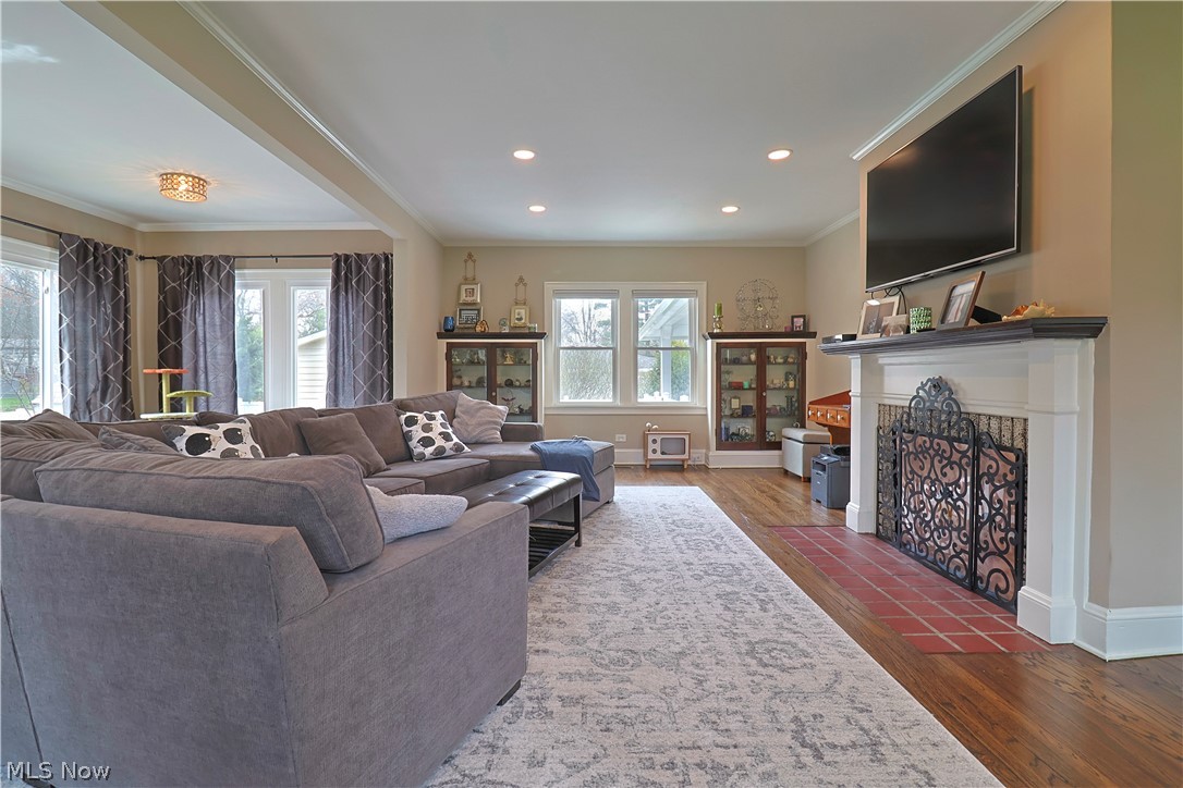 4376 Dover Center Road North Olmsted, OH 44070 - Photo 5 of 34 Living room featuring crown molding, dark hardwood / wood-style floors, and plenty of natural light