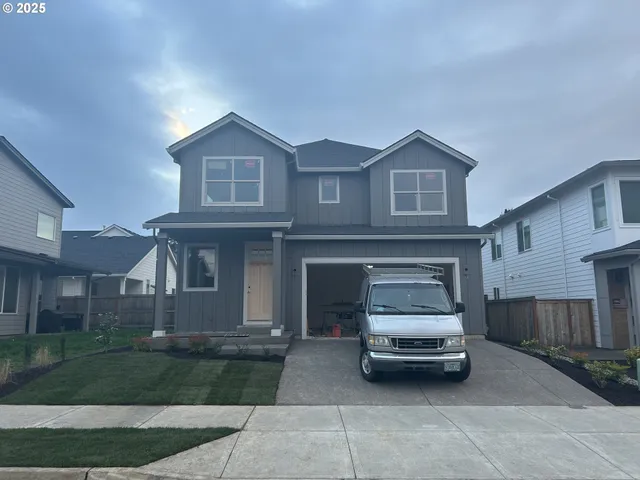 a view of a car parked in front of a brick house