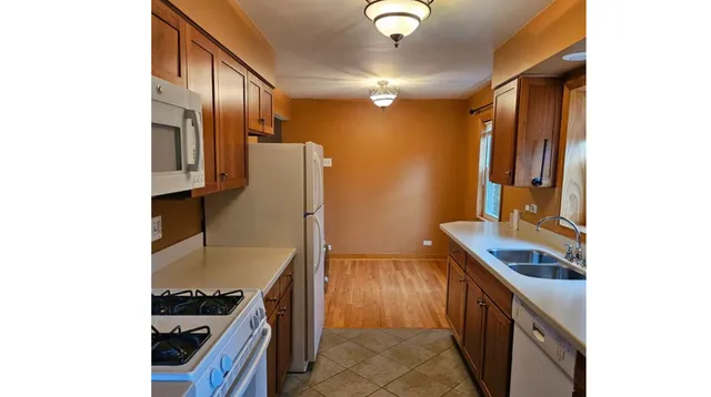 a kitchen with stainless steel appliances granite countertop cabinets and a stove