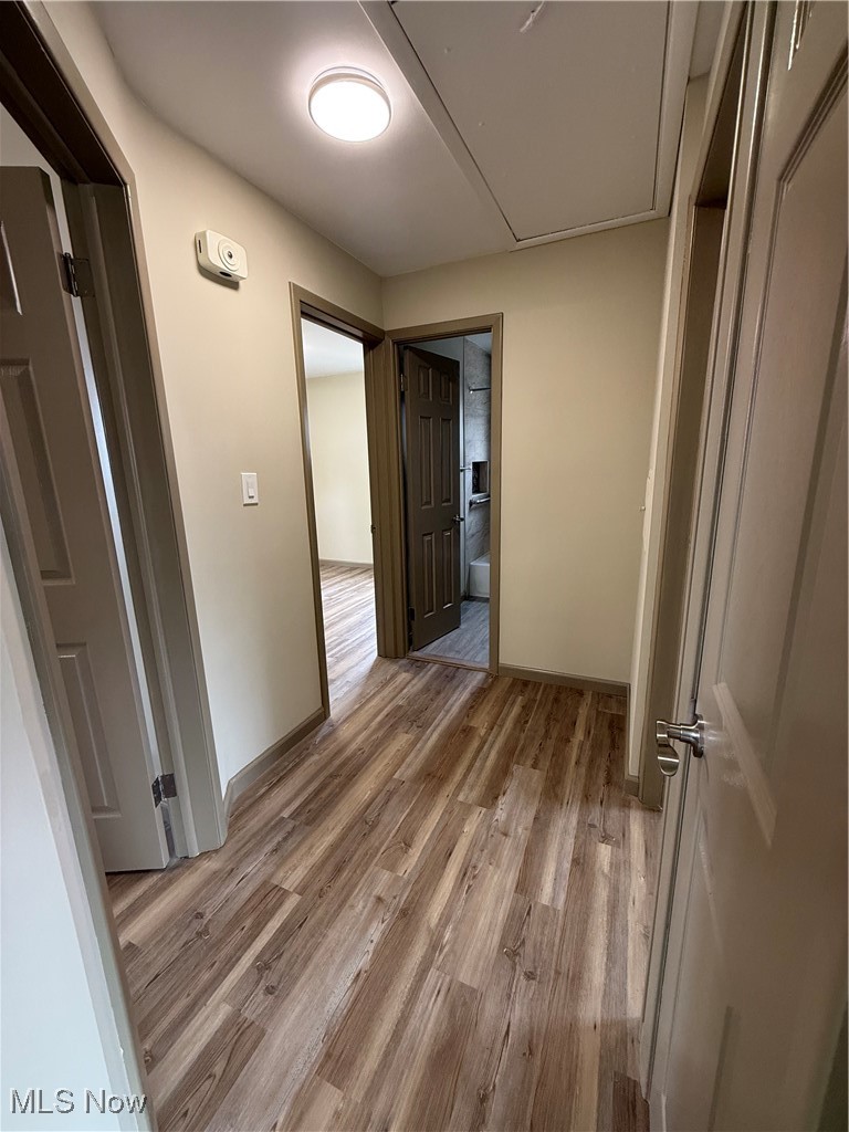 9417 Alexander Road Garfield Heights, OH 44125 - Photo 17 of 38 Hallway featuring light wood-style floors and baseboards