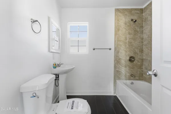 a bathroom with a sink a toilet and bathtub