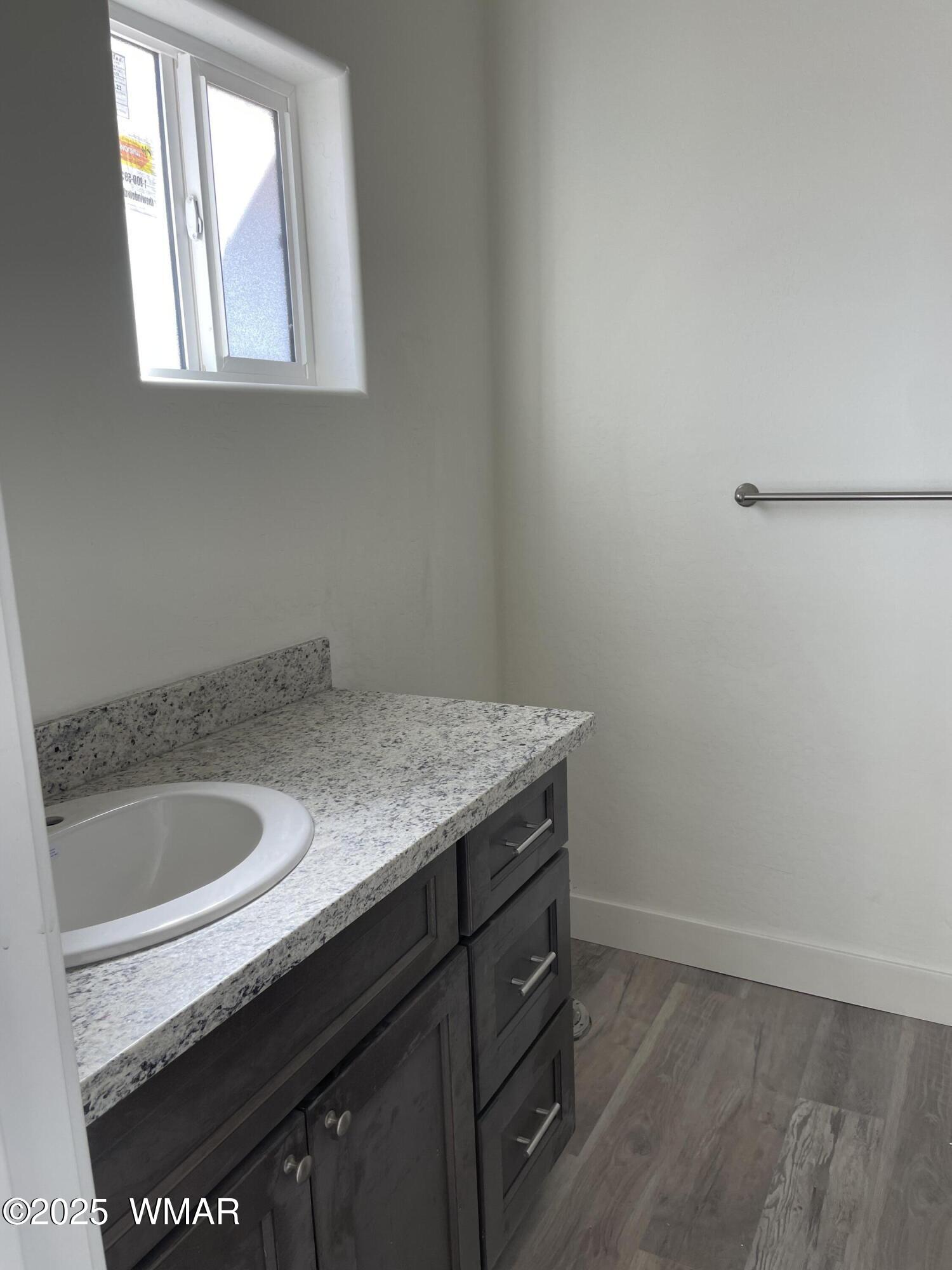 23 South Foothills Boulevard Taylor, AZ 85939 - Photo 12 of 16 a bathroom with a granite countertop sink and a vanity