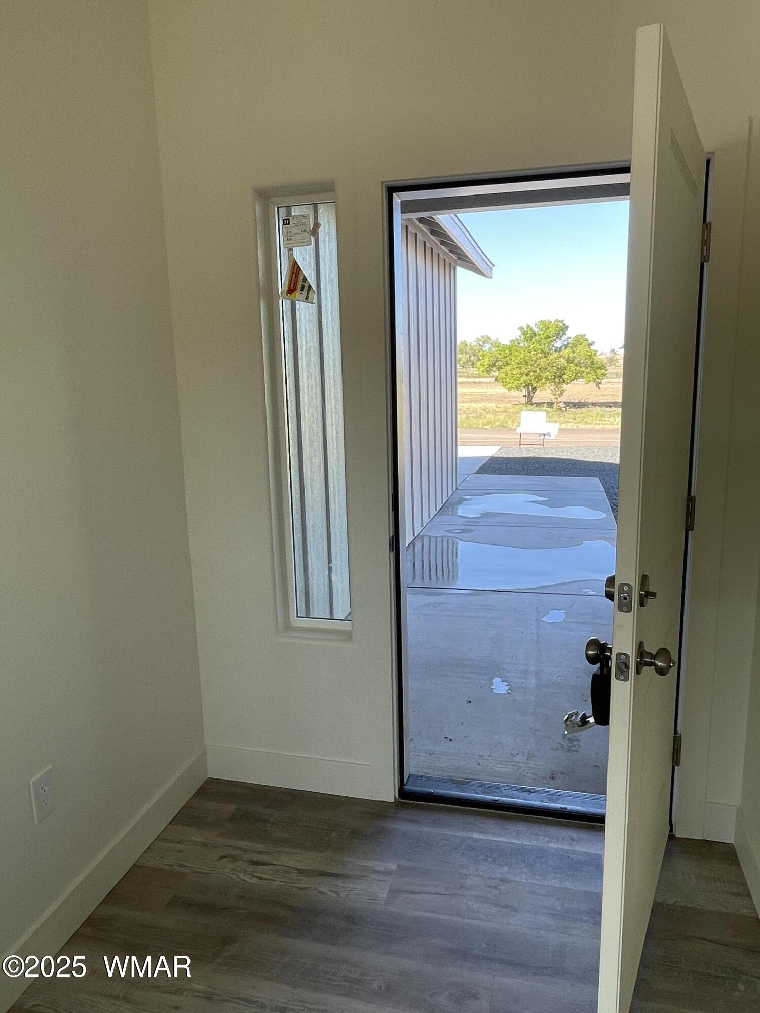 23 South Foothills Boulevard Taylor, AZ 85939 - Photo 16 of 16 an empty room with wooden floor and windows