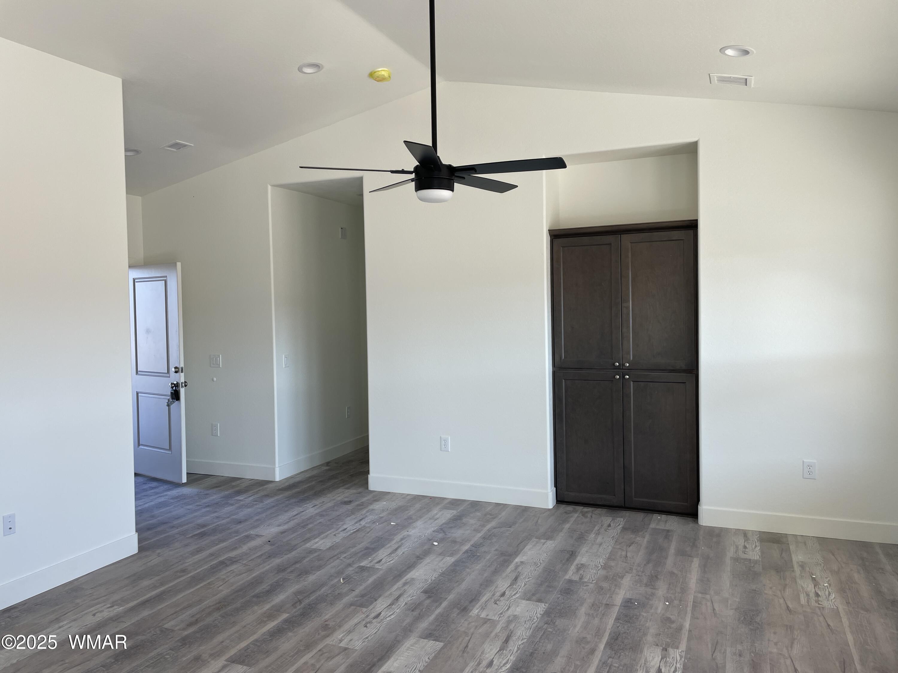 23 South Foothills Boulevard Taylor, AZ 85939 - Photo 7 of 16 a view of a room with wooden floor and a ceiling fan