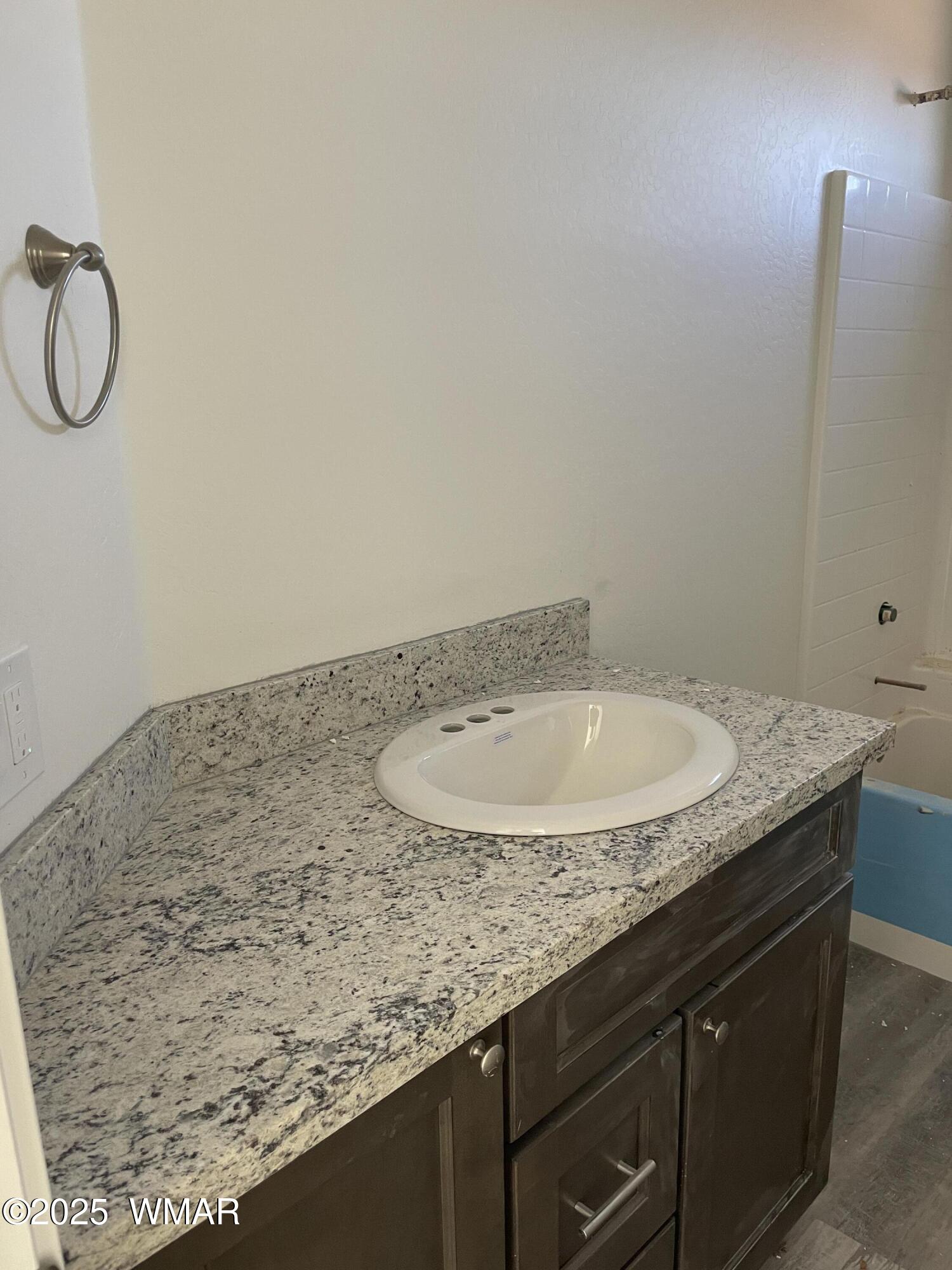 23 South Foothills Boulevard Taylor, AZ 85939 - Photo 10 of 16 a bathroom with a granite countertop sink and a mirror