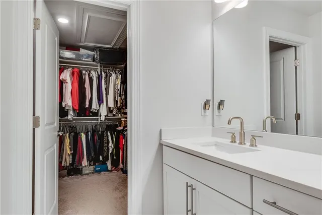 a view of walk in closet with clothes