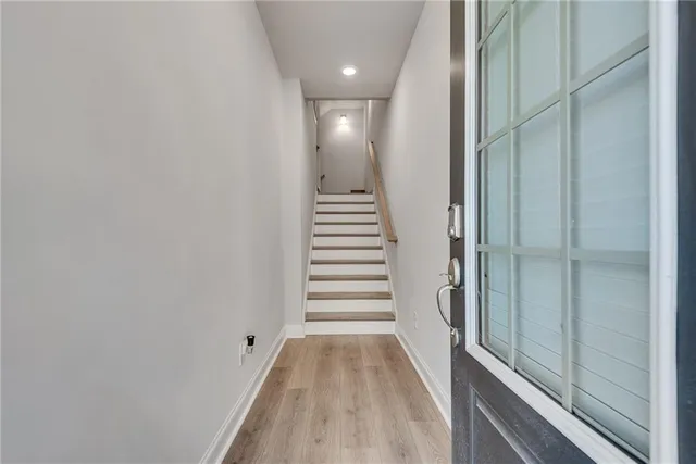 a view of a hallway with stairs and a window