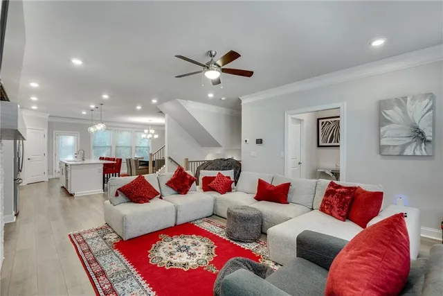 a living room with furniture and a ceiling fan