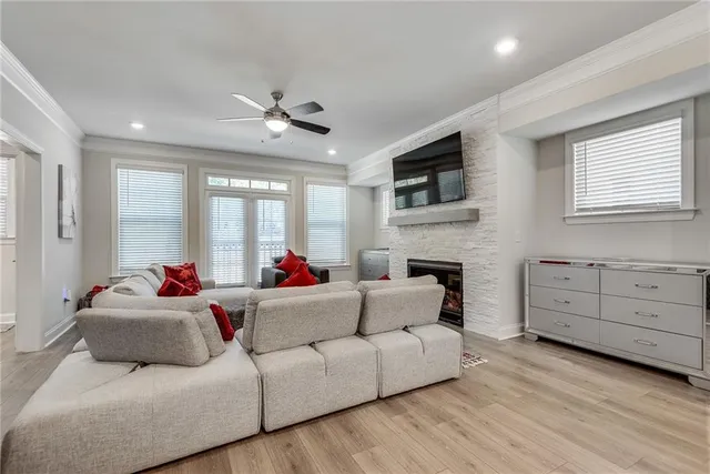 a living room with furniture fireplace and a window
