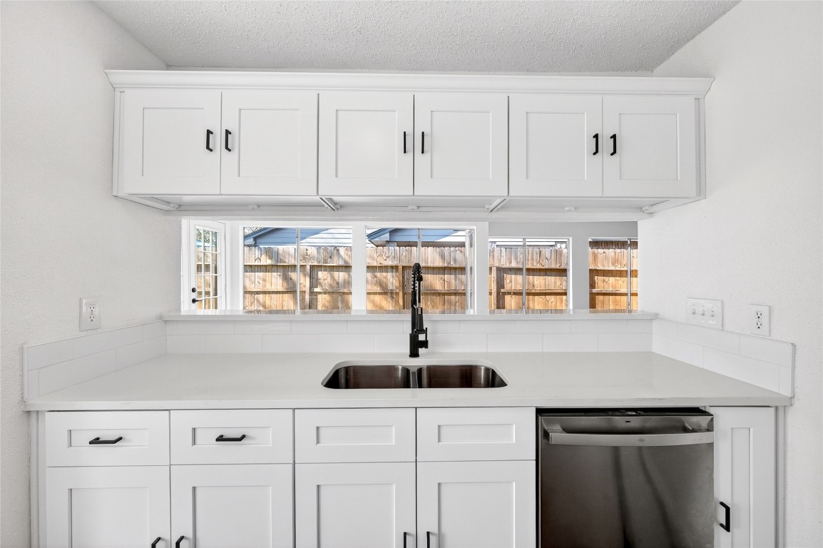 24007 Landing Way Drive Spring, TX 77373 - Photo 17 of 44 a kitchen with white cabinets a sink and dishwasher