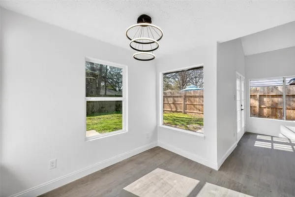 a view of an empty room with windows