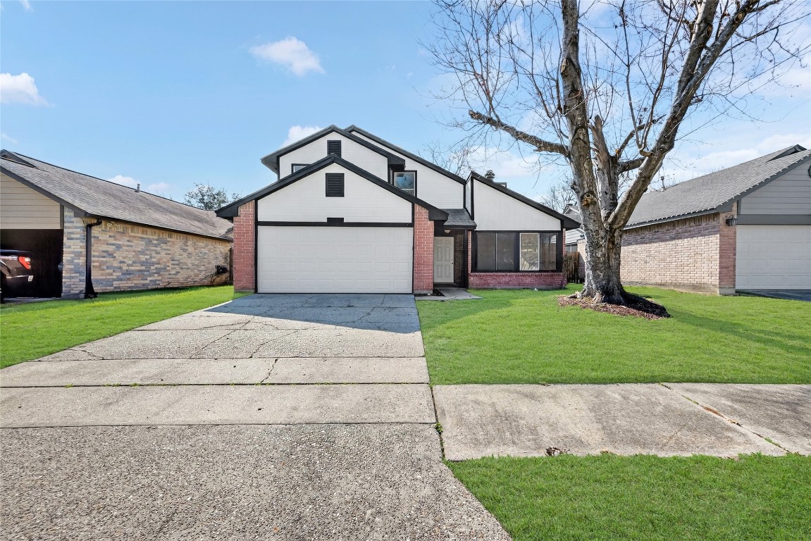 24007 Landing Way Drive Spring, TX 77373 - Photo 2 of 44 a front view of a house with a yard and garage