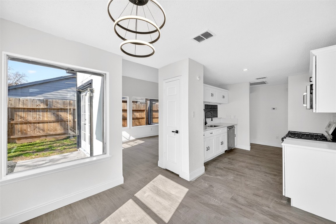 24007 Landing Way Drive Spring, TX 77373 - Photo 21 of 44 a kitchen with stainless steel appliances a white stove top oven cabinets and a window