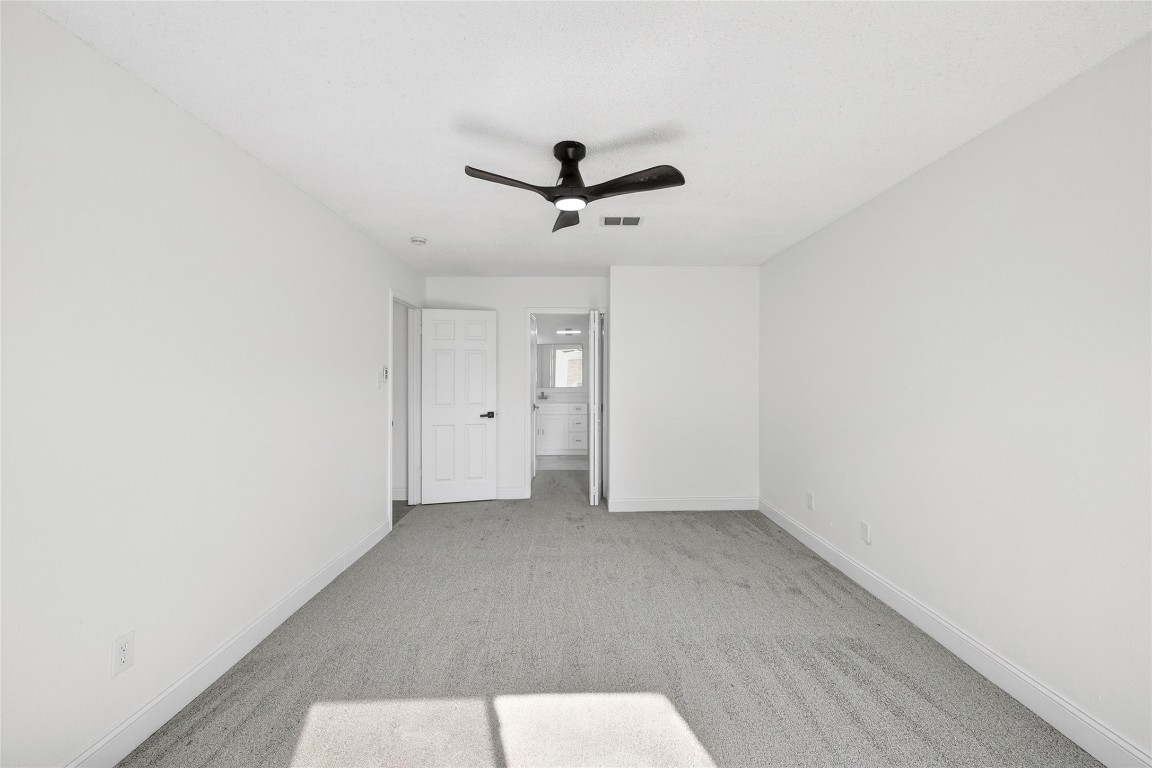 24007 Landing Way Drive Spring, TX 77373 - Photo 26 of 44 an empty room with a ceiling fan and carpet