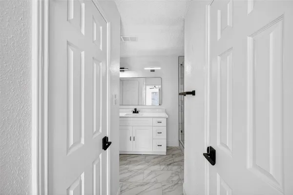 a bathroom with a shower sink vanity and mirror