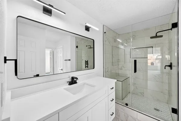 a bathroom with a sink a vanity and a mirror