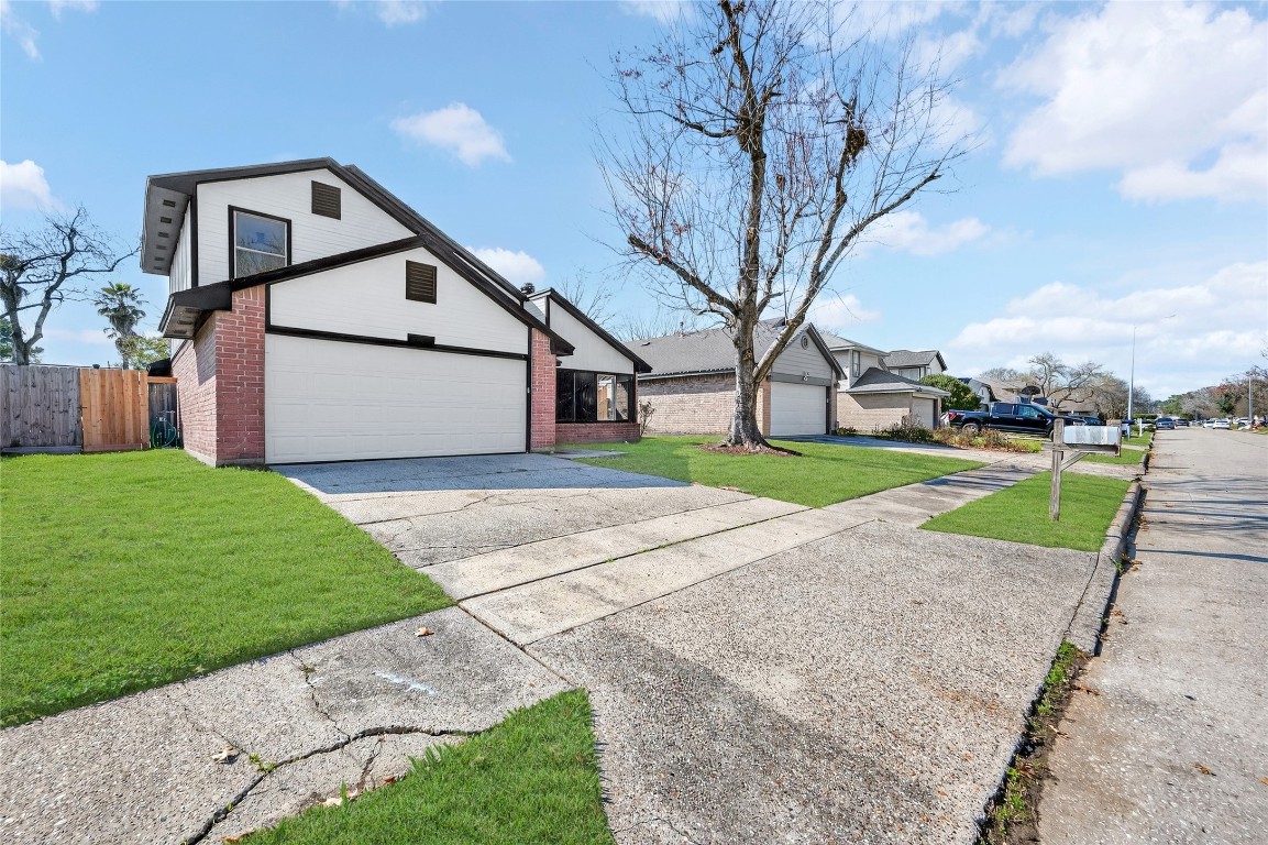 24007 Landing Way Drive Spring, TX 77373 - Photo 3 of 44 a front view of a house with a yard and garage