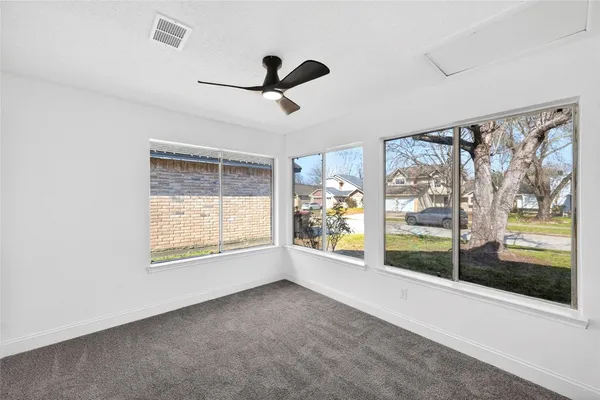 a view of a ceiling fan and a window