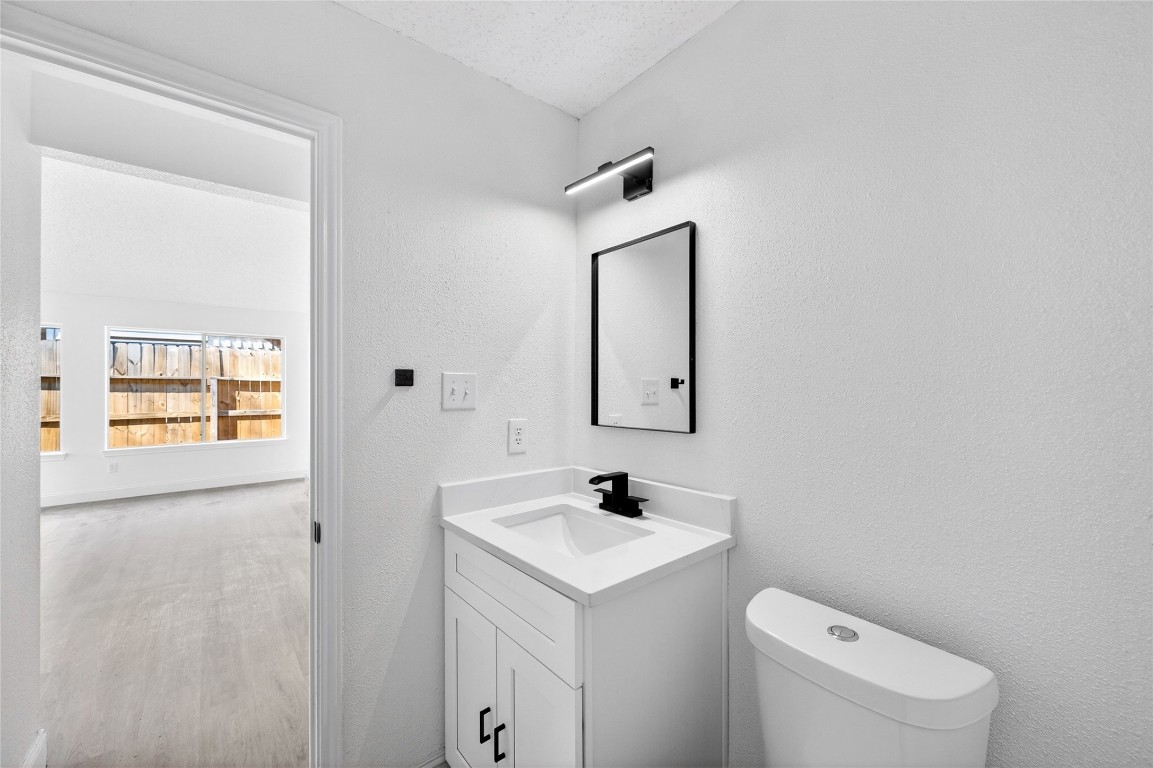 24007 Landing Way Drive Spring, TX 77373 - Photo 40 of 44 a bathroom with a toilet a sink and a mirror