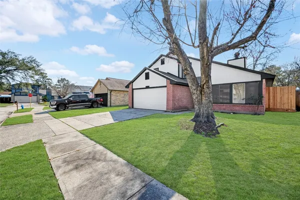 a view of house with backyard