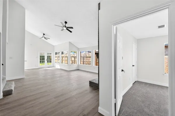 a view of a big room with wooden floor windows and fireplace