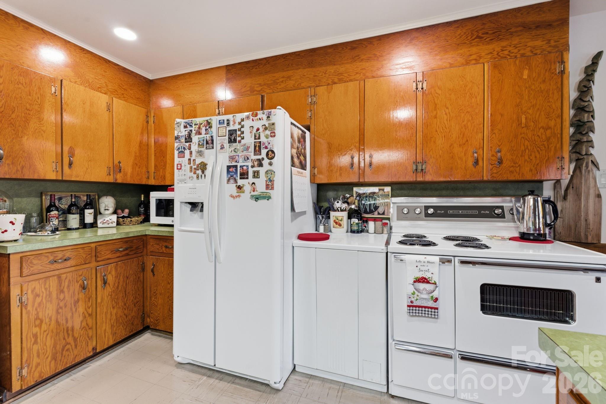 504 Greens Creek Road Sylva, NC 28779 - Photo 11 of 47 a kitchen with refrigerator and cabinets
