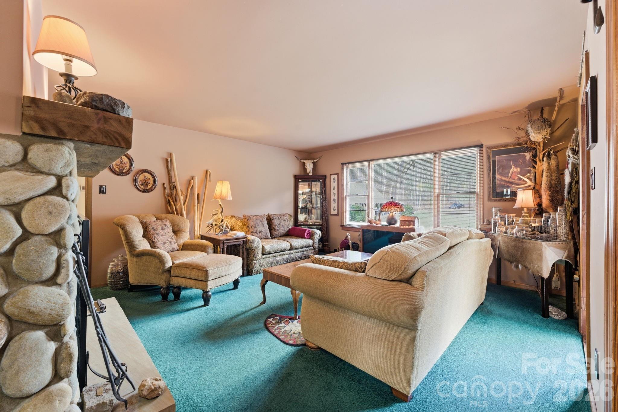 504 Greens Creek Road Sylva, NC 28779 - Photo 18 of 47 a living room with furniture and a flat screen tv