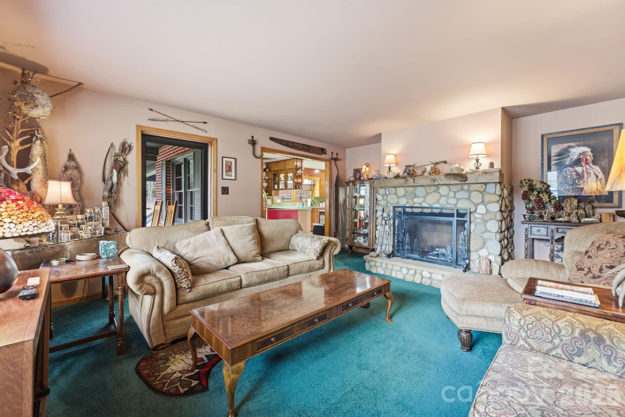 504 Greens Creek Road Sylva, NC 28779 - Photo 19 of 47 a living room with furniture and a fireplace