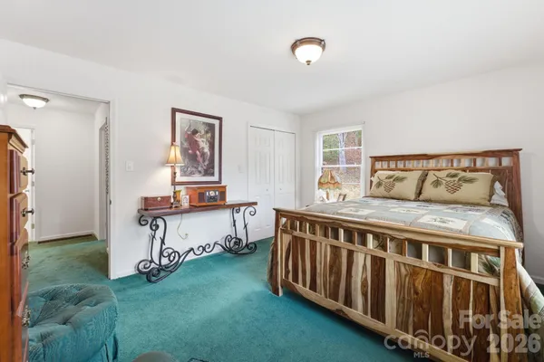 a bedroom with a bed and window