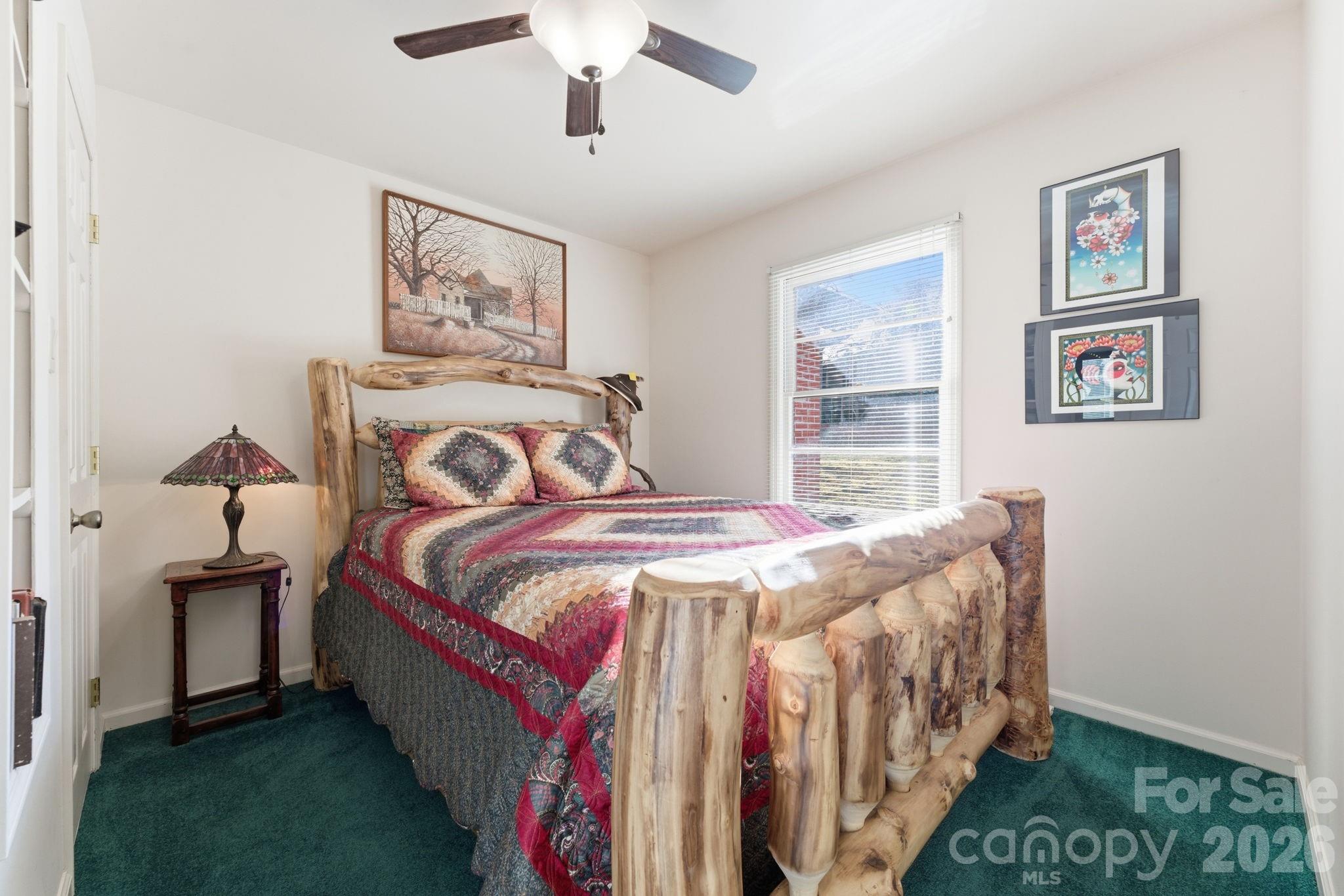 504 Greens Creek Road Sylva, NC 28779 - Photo 29 of 47 a bed sitting in a bedroom next to a window