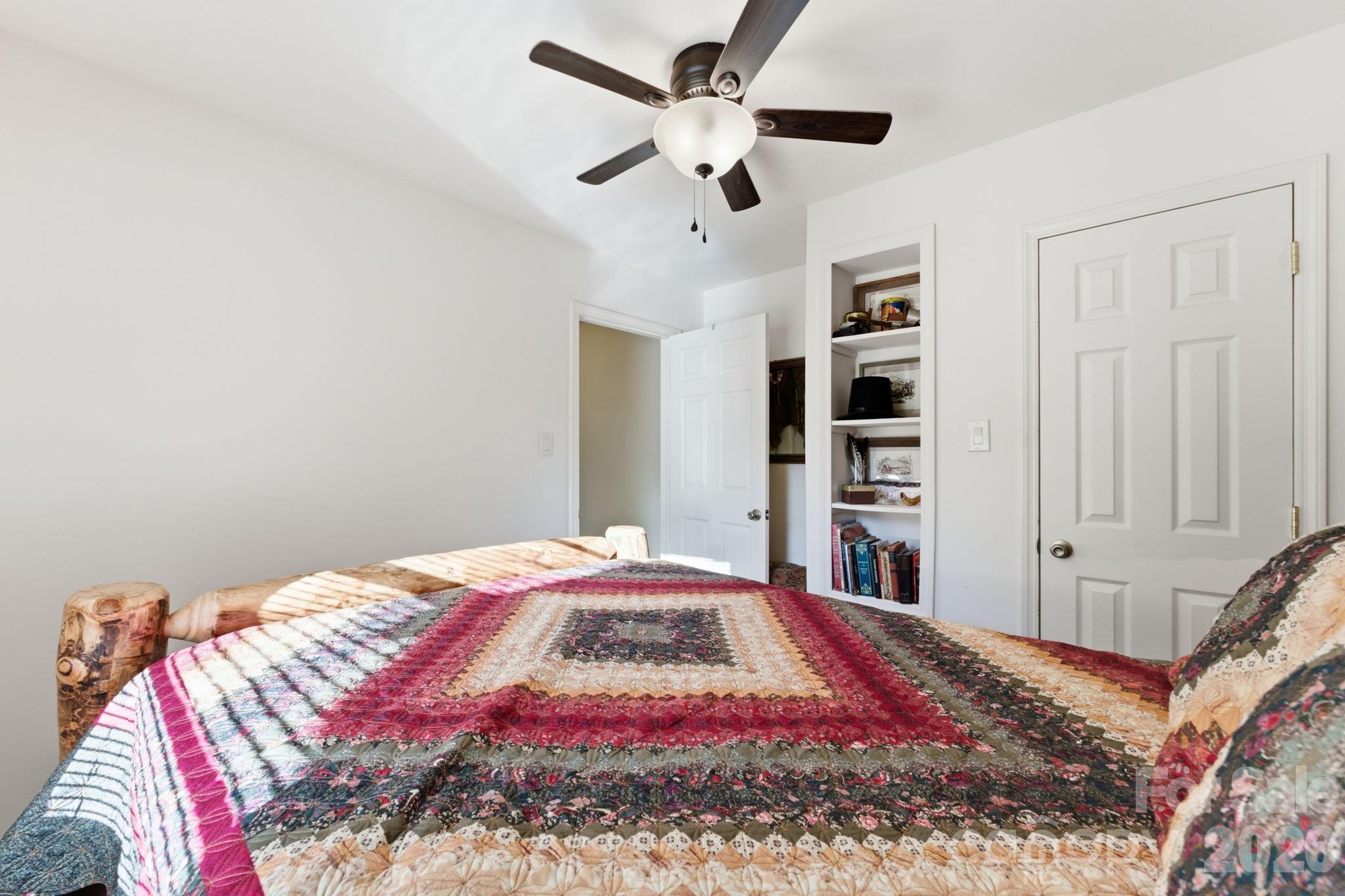 504 Greens Creek Road Sylva, NC 28779 - Photo 30 of 47 a bed sitting in a bedroom next to a window