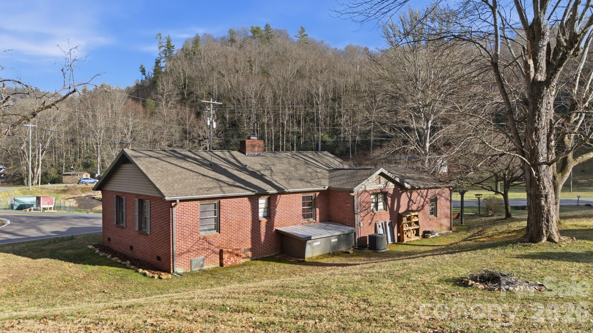 504 Greens Creek Road Sylva, NC 28779 - Photo 3 of 47 a view of a house with a yard covered with snow in the background