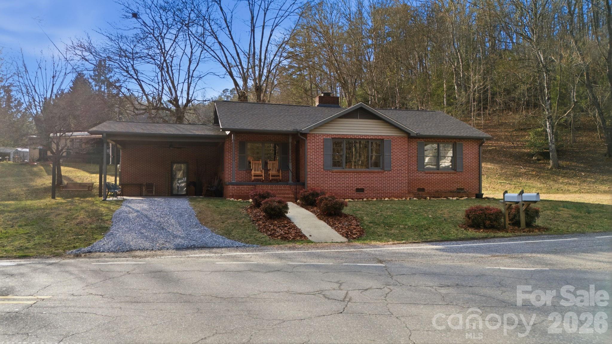 504 Greens Creek Road Sylva, NC 28779 - Photo 39 of 47 a front view of a house with a yard and garage