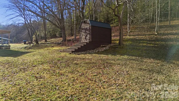 a view of a backyard with wooden fence