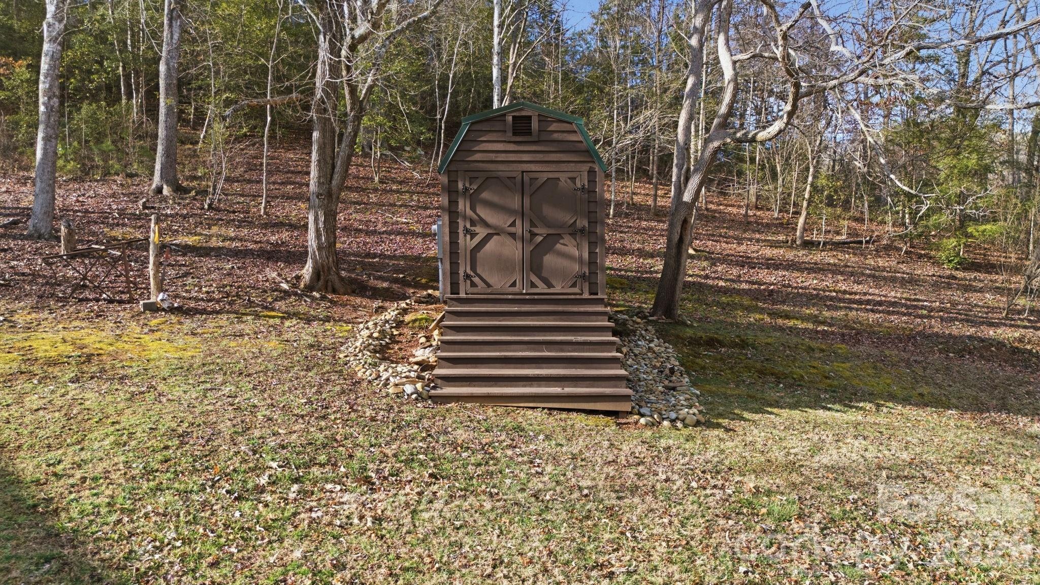 504 Greens Creek Road Sylva, NC 28779 - Photo 5 of 47 a front view of a house with a garden