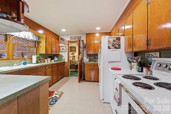 a kitchen with refrigerator and cabinets