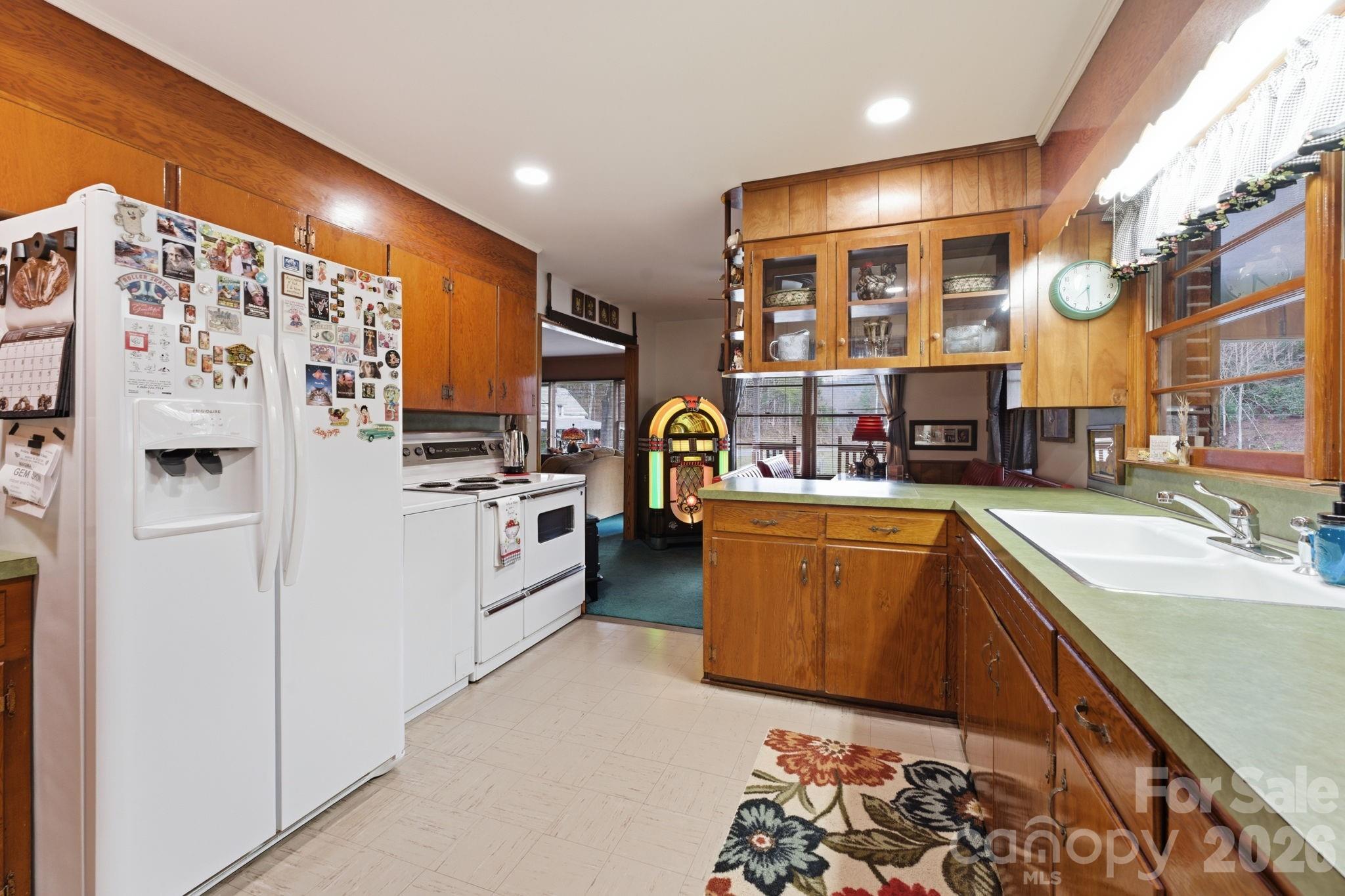 504 Greens Creek Road Sylva, NC 28779 - Photo 10 of 47 a kitchen with stainless steel appliances granite countertop a refrigerator and a sink