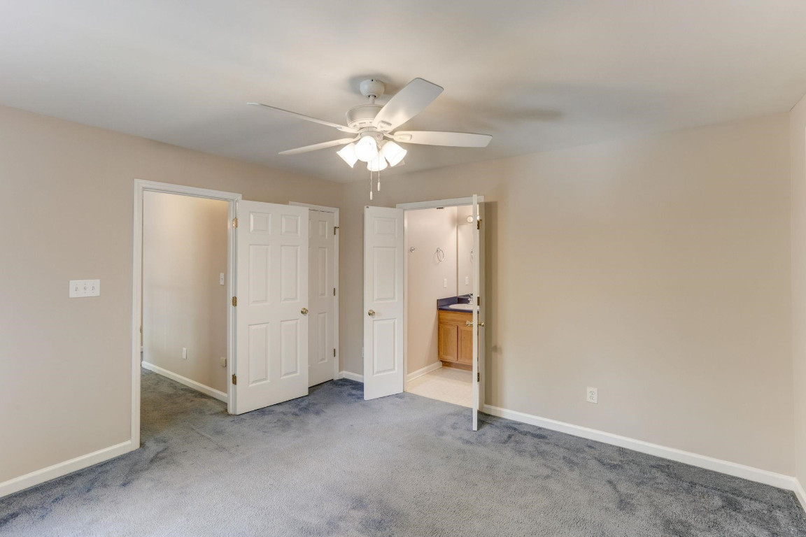 1601 Lethbridge Court Raleigh, NC 27606 - Photo 13 of 17 an empty room with a ceiling fan and a window