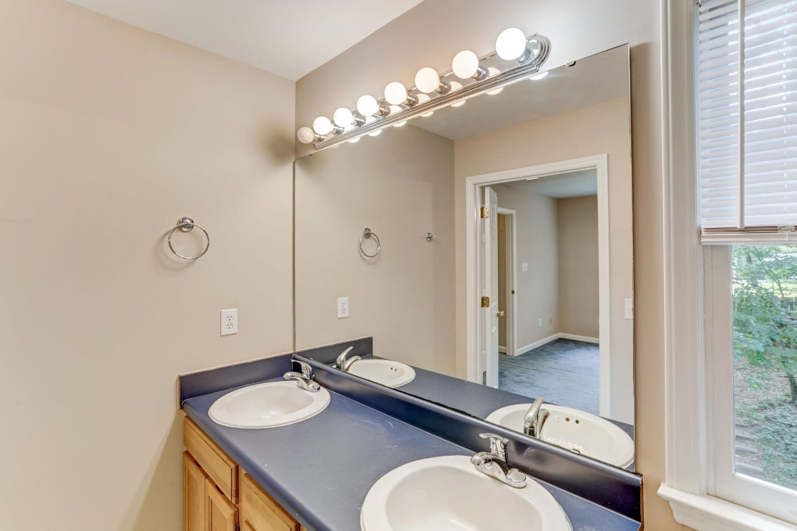 1601 Lethbridge Court Raleigh, NC 27606 - Photo 15 of 17 a bathroom with a sink vanity granite and a mirror