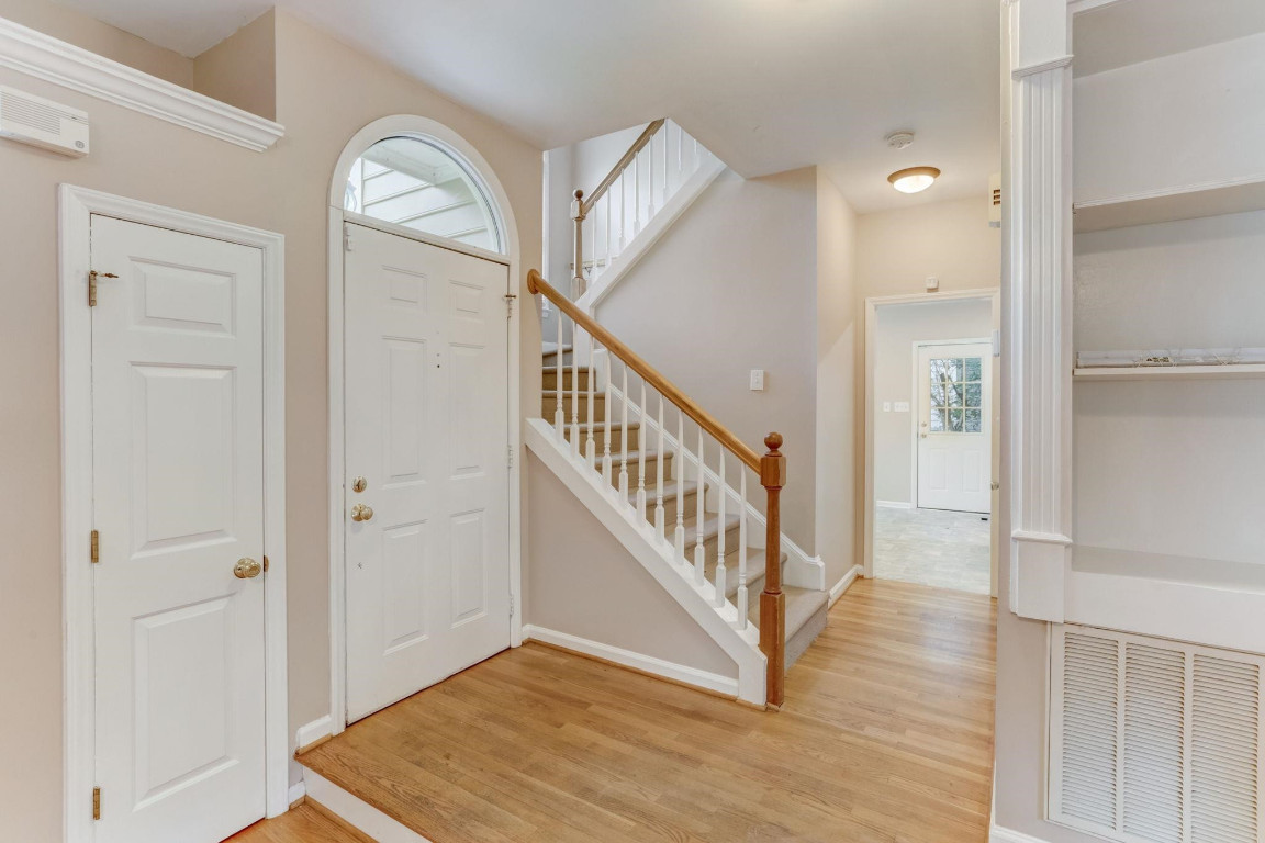 1601 Lethbridge Court Raleigh, NC 27606 - Photo 2 of 17 a view of a livingroom with wooden floor and stairs